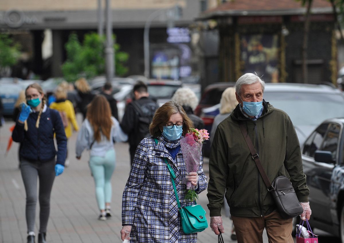 KYIV, UKRAINE- May 26, 2020: People wearing protective masks as a precaution against the outbreak of Coronavirus walk down the street during the coronavirus crisis.