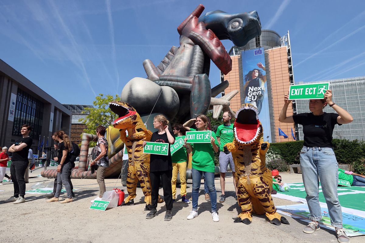 BRUSSELS, BELGIUM - MAY 17: A group of demonstrator gather to protest against the EU Energy Charter Treaty with an inflatable dinosaur 7 meters high and dinosaur costumes at Schuman Square next to the European Union Commission in Brussels, Belgium on May 17, 2022. Dursun Aydemir / Anadolu Agency (Photo by Dursun Aydemir / ANADOLU AGENCY / Anadolu Agency via AFP)