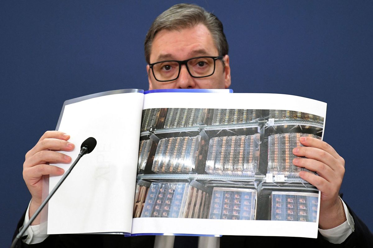 Serbia's President Aleksandar Vucic shows photos of food reserves during a press conference in Belgrade on February 25, 2022. - After a decade in power, the ruling centre-right Serbian Progressive Party (SNS) led by Vucic looks likely to extend their rule over the country, according to recent polls. The country of some 7 million will elect the president, deputies for the 250-seat parliament along with contests in several municipalities. The Kremlin's war in Ukraine, however, has cast a long pall over the vote that observers had earlier predicted would focus on issues like environment, corruption, and rights. (Photo by Nemanja JOVANOVIC / AFP)