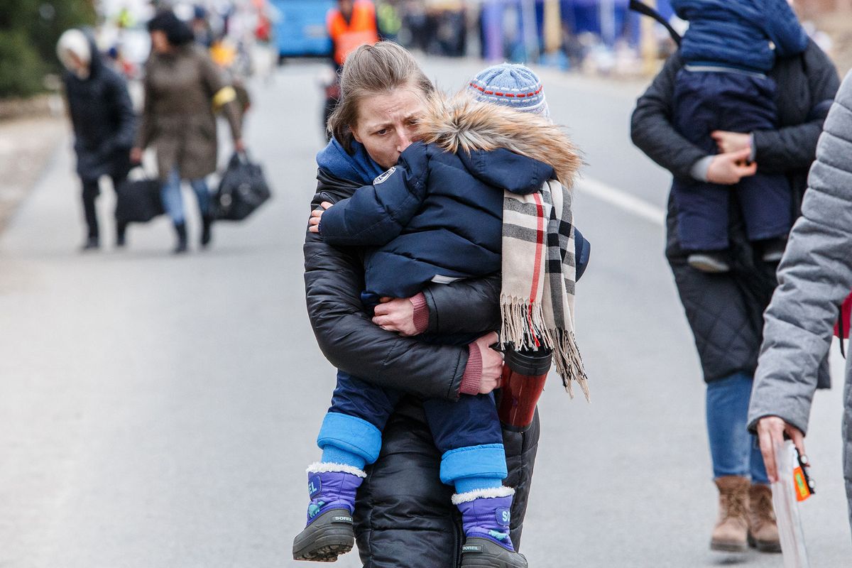 Refugees on Ukrainian-Slovak international border, A woman carries a boy in her arms during the evacuation of Ukrainian refugees through the Uzhgorod-Vysne Nemecke checkpoint on the Ukrainian-Slovak border, Uzhhorod, western Ukraine, on March 9, 2022. (Photo by Serhii Hudak/Ukrinform/NurPhoto) (Photo by Serhii Hudak / NurPhoto / NurPhoto via AFP)