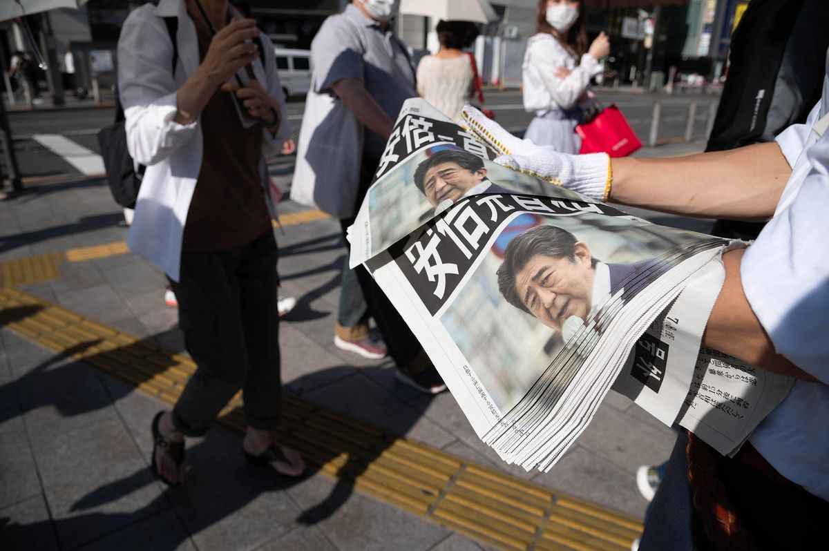 Copies of an extra edition of the Yomiuri Shimbun newspaper with a front page report on former Japanese Prime Minister Shinzo Abe, who was shot during a political event in Nara, are distributed in Tokyo, Japan, on Friday, July 8, 2022. Abe, Japans longest-serving premier and a figure of enduring influence,  was in grave condition after he was shot during a campaign event Friday, an attack that shocked a nation where political violence and guns are rare. Photographer: Akio Kon/Bloomberg via Getty Images