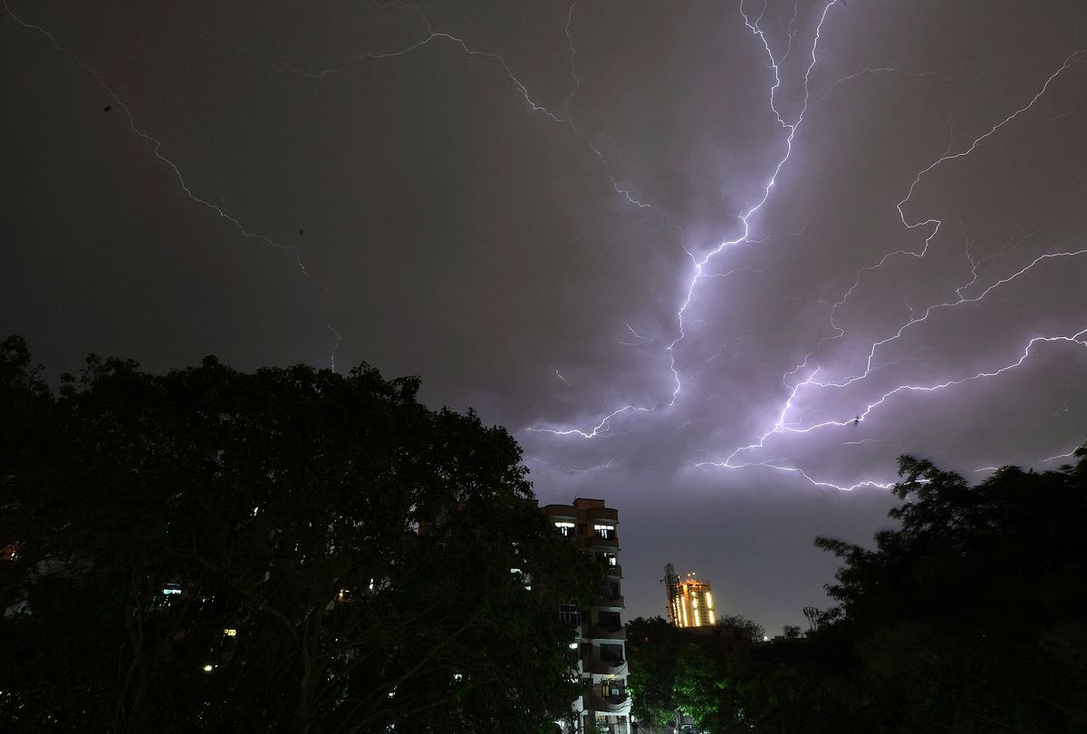 Lightning strikes over residential apartments during a thunderstorm on the outskirts of the Indian capital New Delhi on May 2, 2018. - Dust storms tore across northern India killing at least 77 people and injuring 143 as trees and walls were flattened by powerful winds, officials said May 3. (Photo by PRAKASH SINGH / AFP)