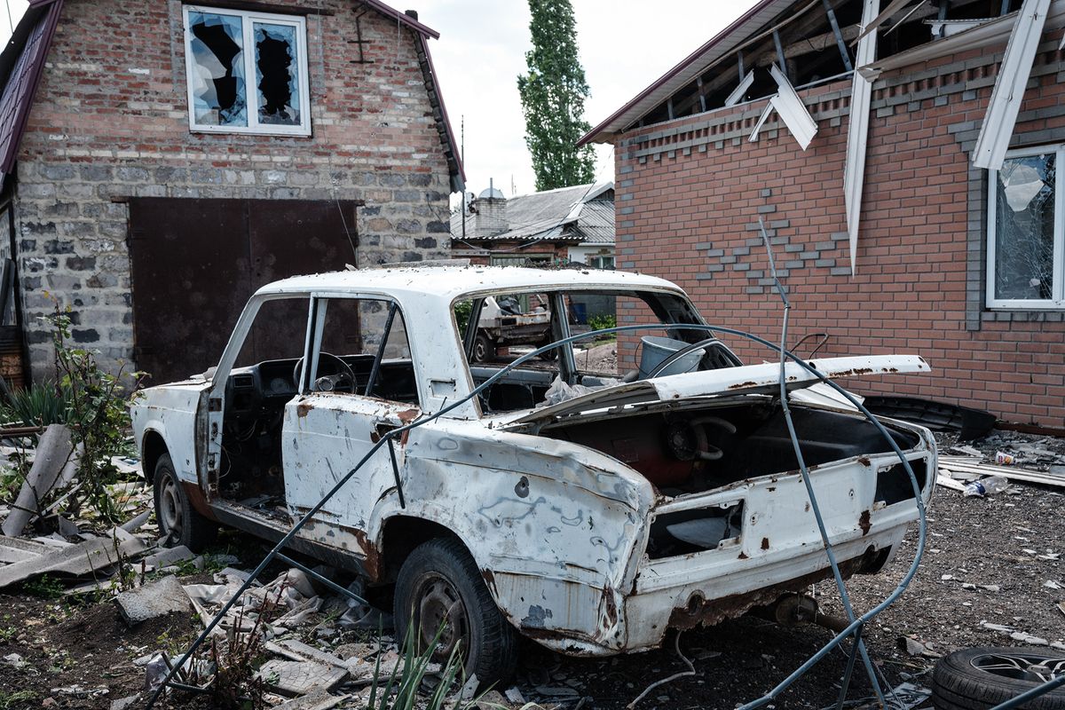 A destroyed car is parked outside a damaged home in Toretsk, eastern Ukraine, on May 16, 2022, on the 82nd day of the Russian invasion of Ukraine. (Photo by Yasuyoshi CHIBA / AFP)