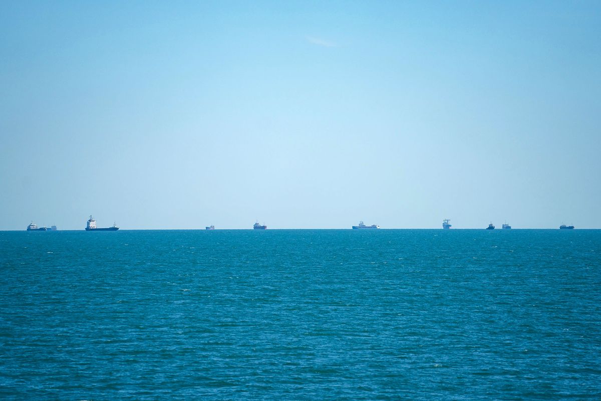 1241470056 Cargo ships and bulk carriers moored offshore while waiting for port access in the Black Sea, near the shipping port of Constanta, Romania, on Tuesday, June 21, 2022. With Ukraine's Black Sea ports scattered with mines and Russia effectively blocking shipping in the area, countries from Turkey to the US have been grappling for a solution to get Ukrainian grain moving again. Photographer: Andrei Pungovschi/Bloomberg via Getty Images