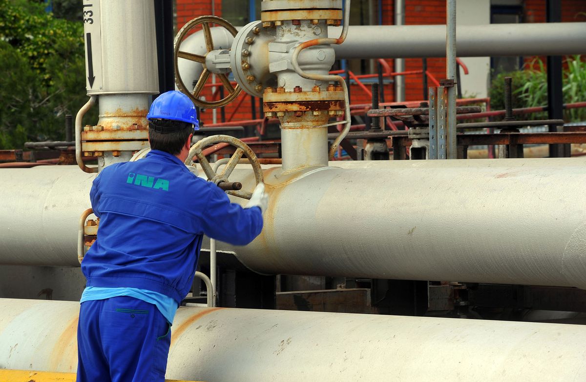 169398584 An employee adjusts a pipeline valve at the INA Industrije Nafte d.d. oil refinery in Urinj, near Rijeka, Croatia, on Thursday, May 23, 2013. Croatia, whose economic development was stifled by Europe's bloodiest fighting since World War II, is trying to revive growth after four years of recession or stagnation. Photographer: Oliver Bunic/Bloomberg via Getty Images