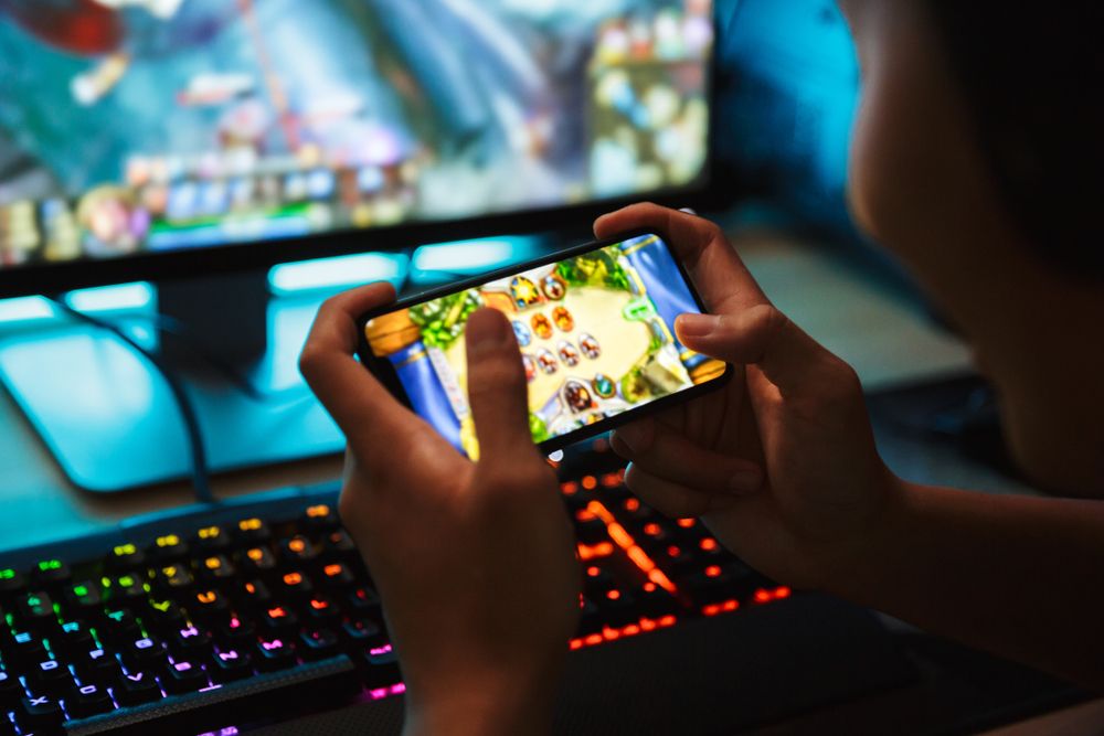 Portrait,Of,Teenage,Gamer,Boy,Playing,Video,Games,On,Smartphone