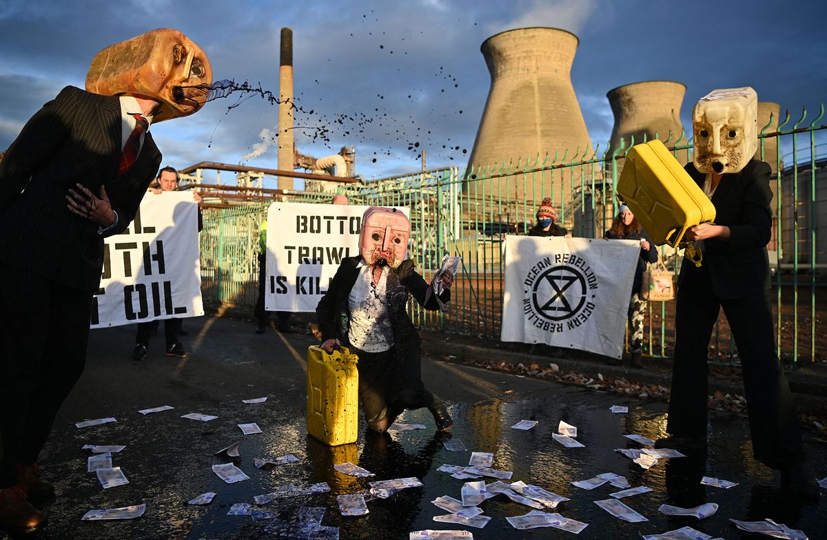 Oil Heads, climate activists from the Ocean Rebellion group, demonstrate outside the INEOS intergrated refinery and petrochemicals centre plant in Grangemouth, Scotland, during the COP26 UN Climate Change Conference taking place in Glasgow, on November 2, 2021. - World leaders meeting at the COP26 climate summit in Glasgow will issue a multibillion-dollar pledge to end deforestation by 2030 but that date is too distant for campaigners who want action sooner to save the planet's lungs. (Photo by Ben STANSALL / AFP)