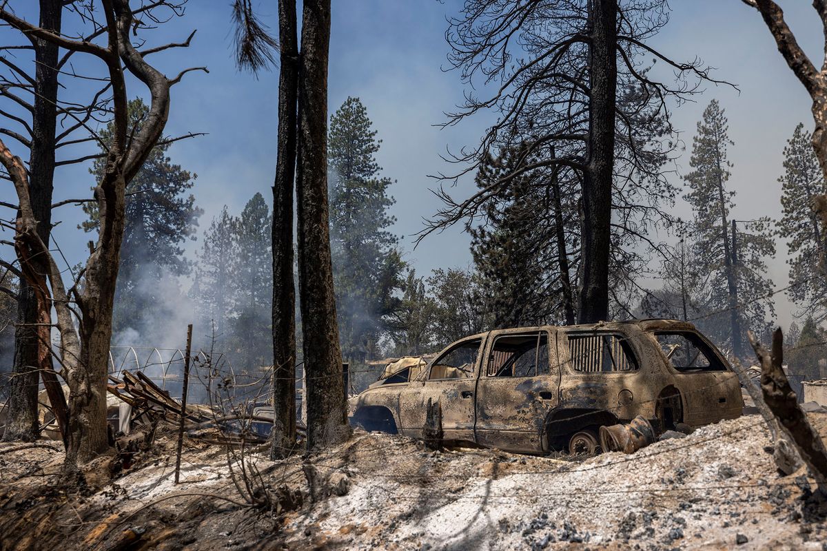 Destroyed property is left in its wake as the Oak Fire chews through the forest near Midpines, northeast of Mariposa, California, on July 23, 2022. - The fire is burning west of Yosemite National Park where the Washburn Fire has threatened the giant sequoia trees of the Mariposa Grove. (Photo by DAVID MCNEW / AFP)