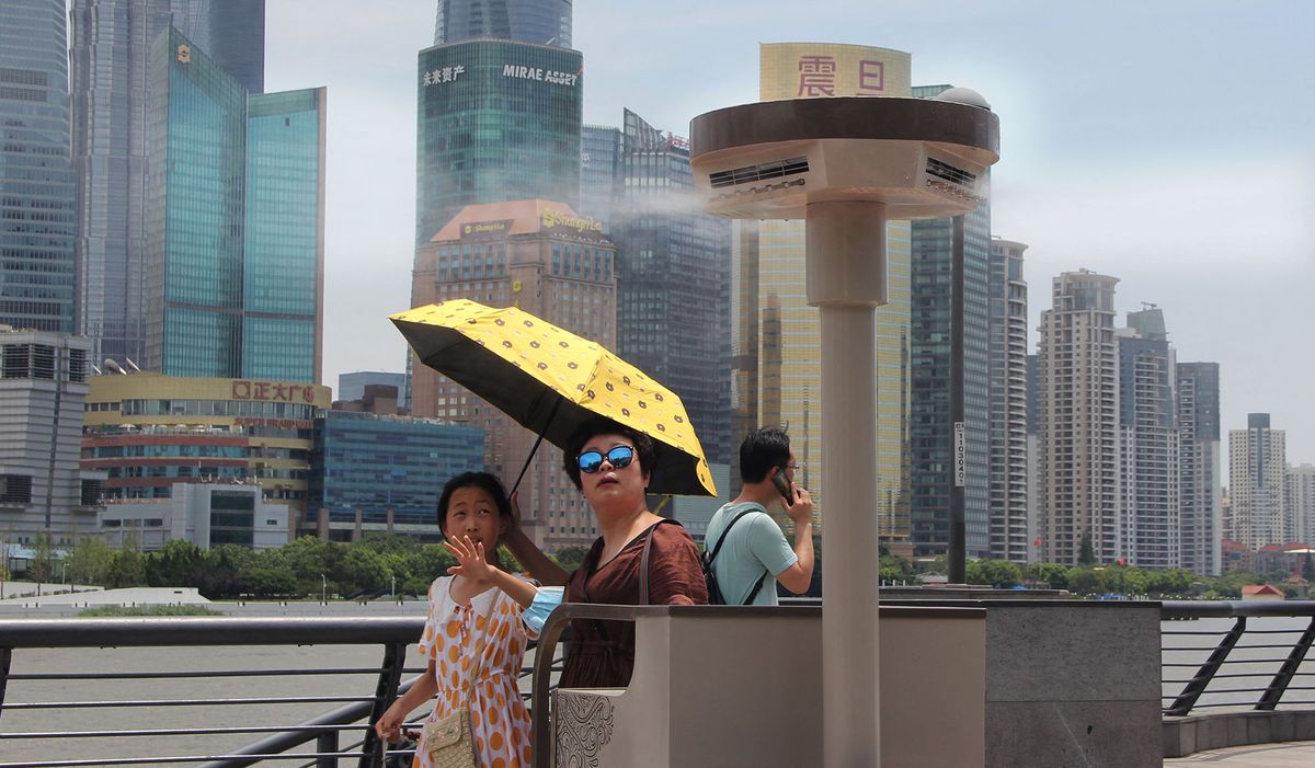As heatwave continues in Shanghai, mobile water mist spray machines are seen at Chenyi Square near the bund in Shanghai, China, 15 July 2021. (Photo by stringer / stringer / Imaginechina via AFP)