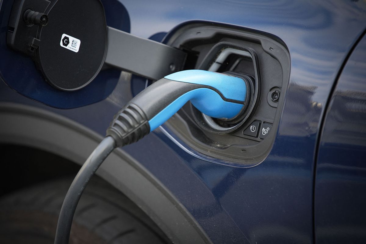 Detail of a Ford car is seen being charged via a cable from a charger in Warsaw, Poland on 14 June, 2022. (Photo by STR/NurPhoto) (Photo by NurPhoto / NurPhoto via AFP)