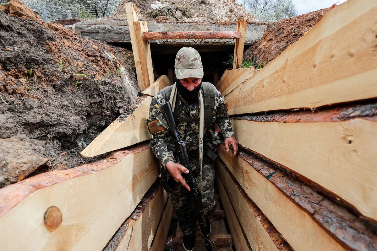 Ukrainian Military In Kharkiv Amid Russian Invasion, A Ukrainian soldier with a gun moves in a trench at an undisclosed location in Kharkiv Oblast, a few kilometres from the Russian border where tense crossfire is ongoing, amid the Russian invasion, in Kharkiv Oblast, Ukraine, 27 April 2022. The United States, United Kingdom and many countries have imposed sanctions on Moscow but Russia’s invasion has continued. (Photo by Ceng Shou Yi/NurPhoto) (Photo by Ceng Shou Yi / NurPhoto / NurPhoto via AFP)