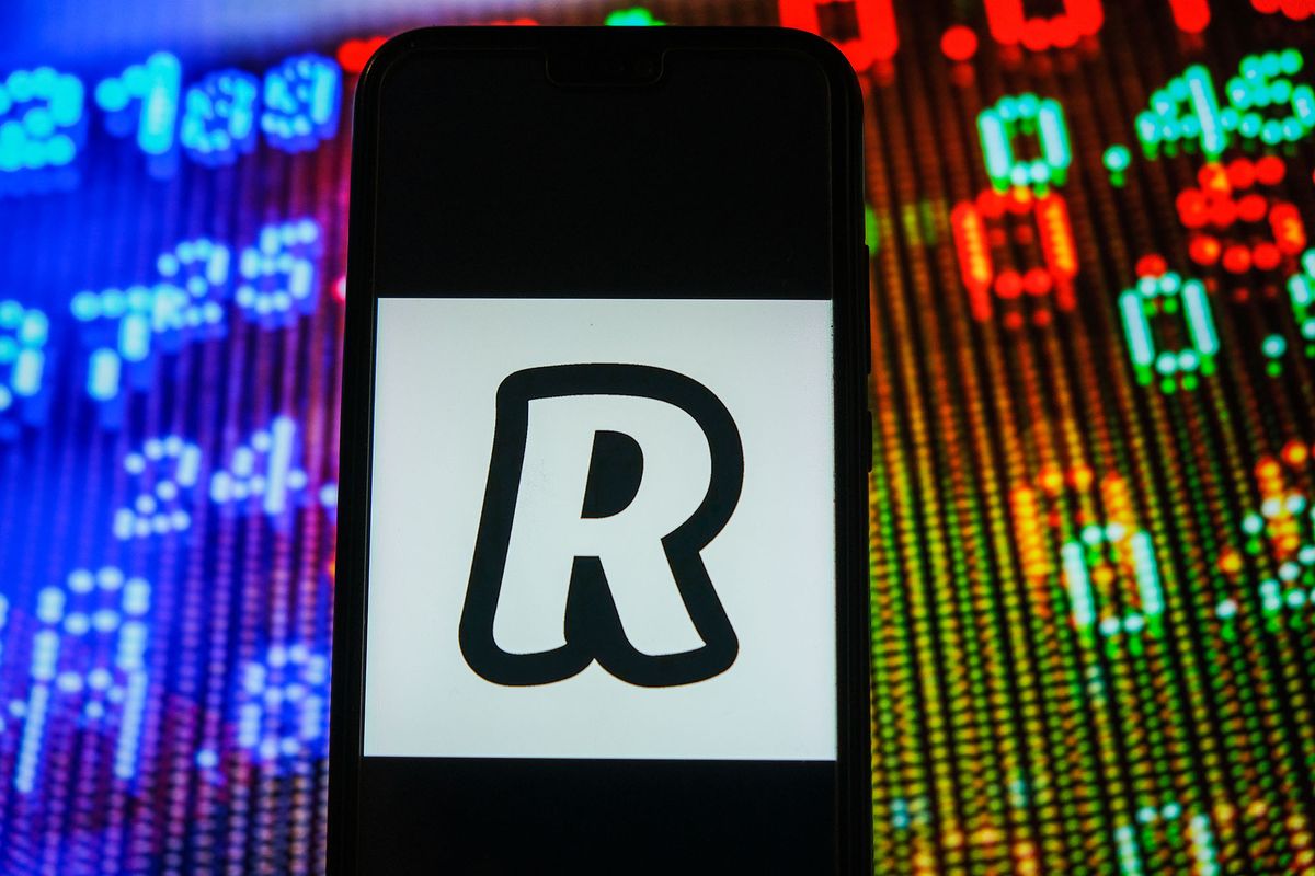 1230440500 POLAND - 2021/01/05: In this photo illustration, a Revolut logo seen displayed on a smartphone with stock market prices in the background. (Photo Illustration by Omar Marques/SOPA Images/SOPA Images/LightRocket via Getty Images)