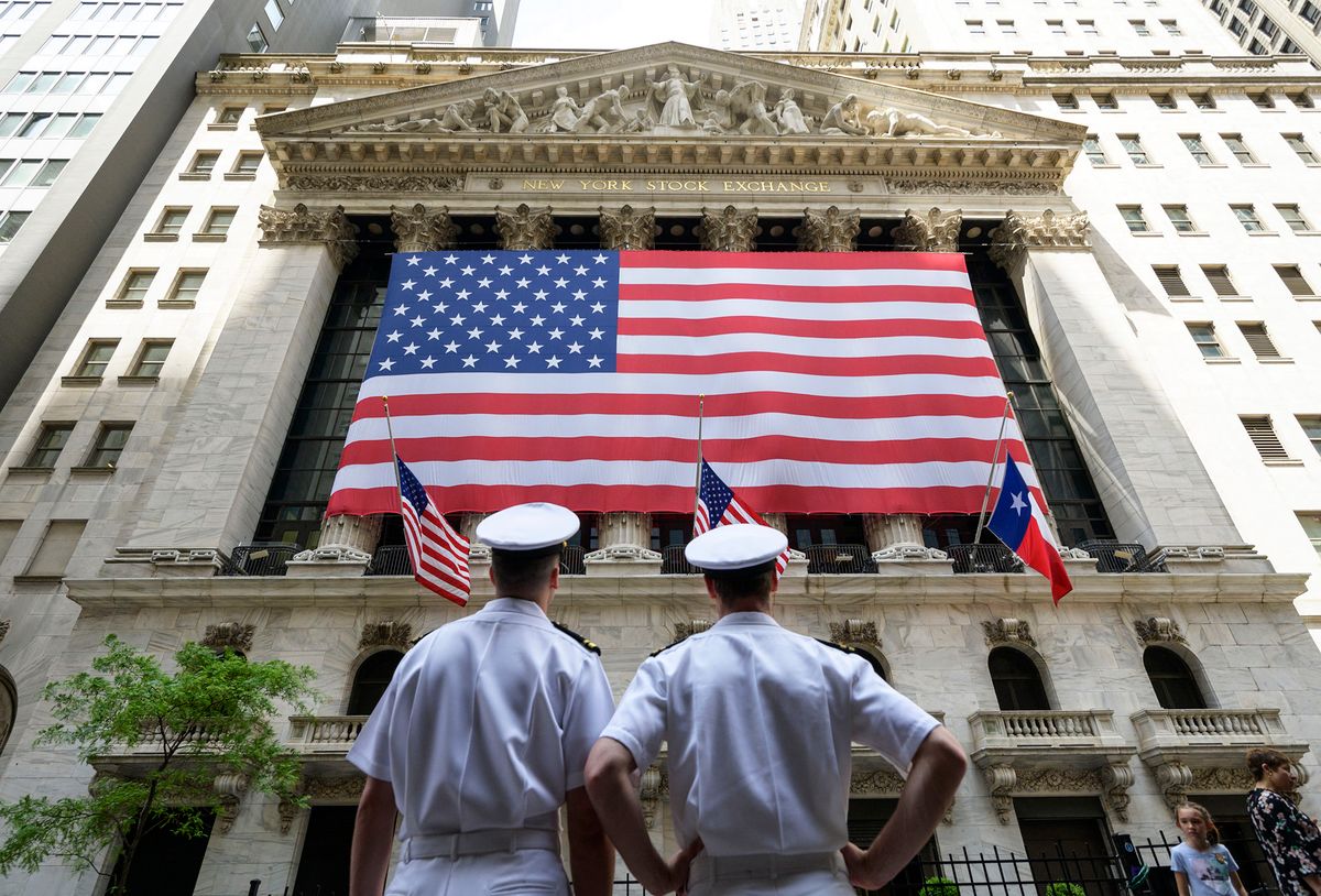 Members of the United States Navy look at the New York Stock Exchange (NYSE) in New York on May 27, 2022. (Photo by Angela Weiss / AFP)