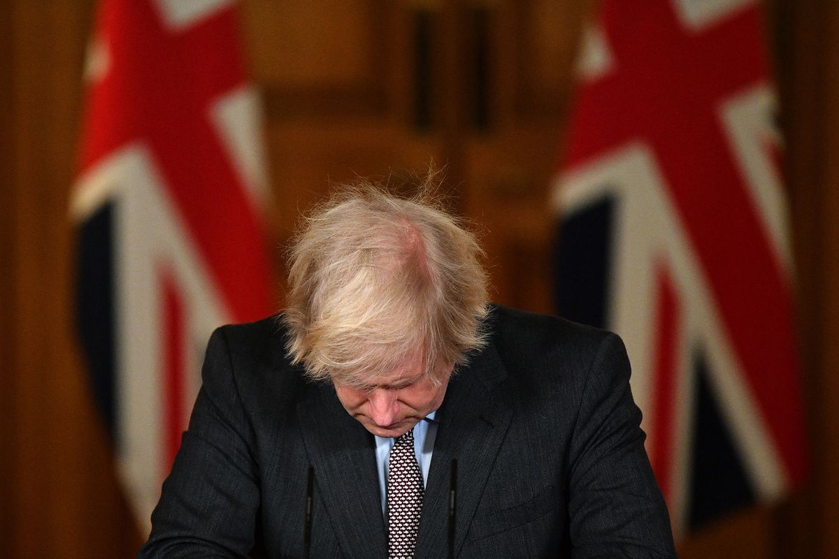 (FILES) In this file photo taken on January 26, 2021 Britain's Prime Minister Boris Johnson looks down at the podium as he attends a virtual press conference inside 10 Downing Street in central London. - Boris Johnson will resign as Conservative party leader on July 7, 2022, the BBC reported, paving the way for a successor to replace him as British prime minister, after dozens of his ministers quit the government. (Photo by JUSTIN TALLIS / POOL / AFP)