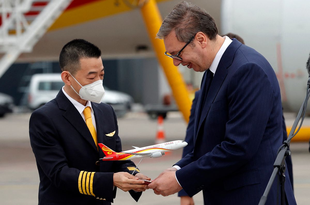 SERBIA-BELGRADE-CHINA-DIRECT FLIGHT, (220717) -- BELGRADE, July 17, 2022 (Xinhua) -- Serbian President Aleksandar Vucic (R) receives a gift from a Chinese pilot during a welcoming ceremony at Nikola Tesla Airport in Belgrade July 16, 2022. China's Hainan Airlines on Saturday opened a direct flight to link Beijing, capital of China, and Belgrade, capital of Serbia. (Photo by Predrag Milosavljevic/Xinhua) (Photo by Predrag Milosavljevic / XINHUA / Xinhua via AFP)