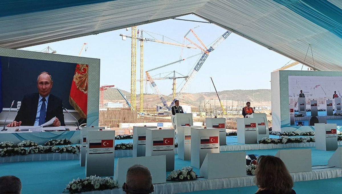 6484226 10.03.2021 Russian President Vladimir Putin is seen on a screen during the launch ceremony of the construction of Akkuyu Nuclear Power Plant's energy unit 3 being built by Rosatom, in the province of Mersin, Turkey. Turan Salc? / Sputnik (Photo by Turan Salc? / Sputnik / Sputnik via AFP)