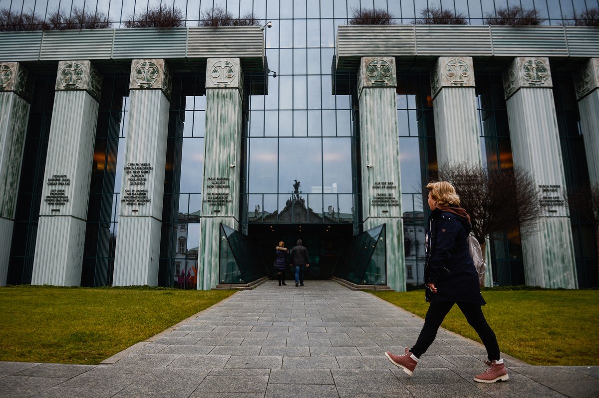 A woman walks in front of the Supreme Court in Warsaw.