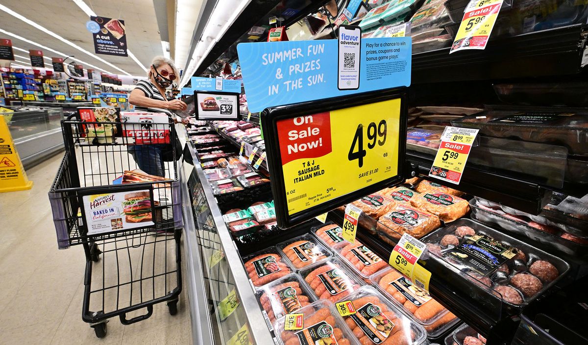 A woman checks an item from the meat department while grocery shopping at a supermarket in Alhambra, California, on July 13, 2022. - US consumer price inflation surged 9.1 percent over the past 12 months to June, the fastest increase since November 1981, according to government data released on July 13. Driven by record-high gasoline prices, the consumer price index jumped 1.3 percent in June, the Labor Department reported. (Photo by Frederic J. BROWN / AFP)