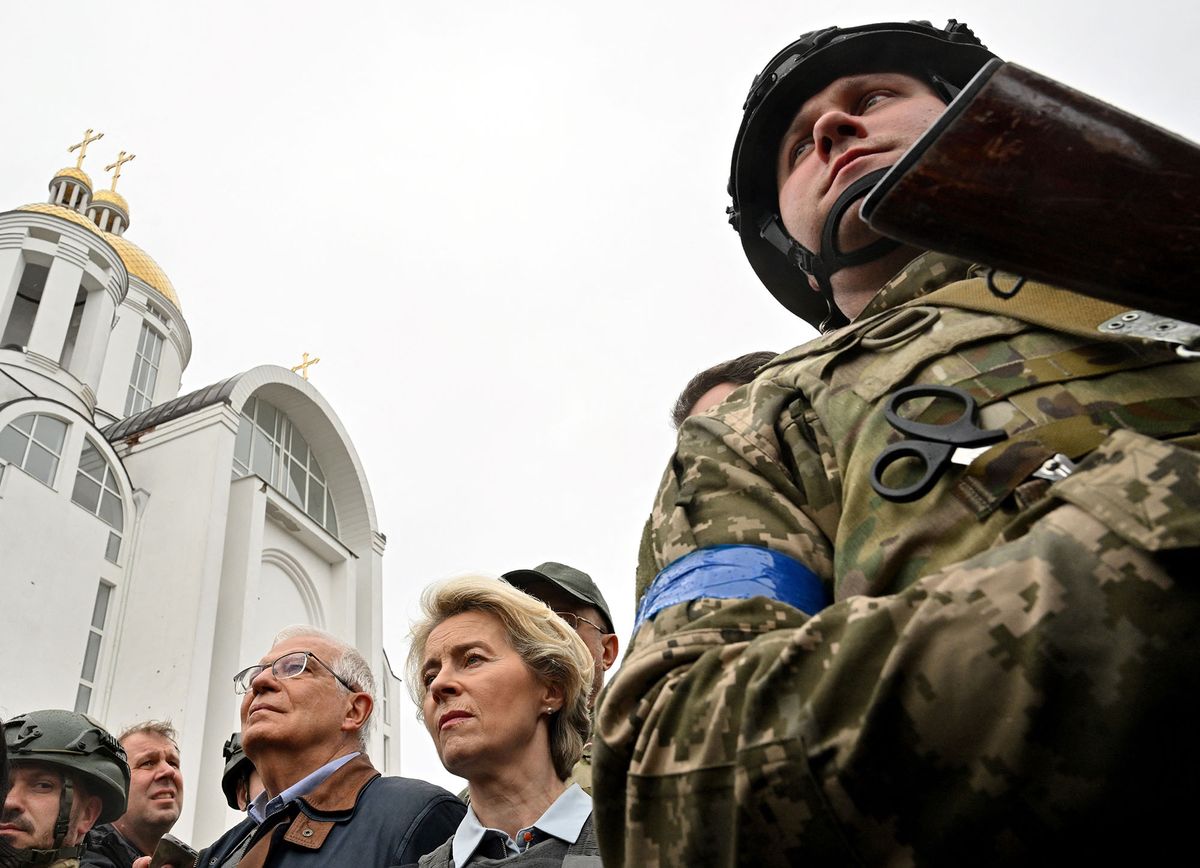 European Commission President Ursula von der Leyen and European Union High Representative for Foreign Affairs and Security Policy Josep Borrell stand outside a church as they visit a mass grave in the town of Bucha, northwest of Kyiv on April 8, 2022. - European Commission President Ursula von der Leyen on April 8, 2022, visited a mass grave in Bucha, a town outside Kyiv where Russian forces are accused by Ukraine's allies of carrying out atrocities against civilians. An AFP journalist reported that von der Leyen was in the town north of the capital as part of a trip to shore up support for Ukraine alongside the bloc's foreign policy chief Josep Borrell. (Photo by Sergei SUPINSKY / AFP)