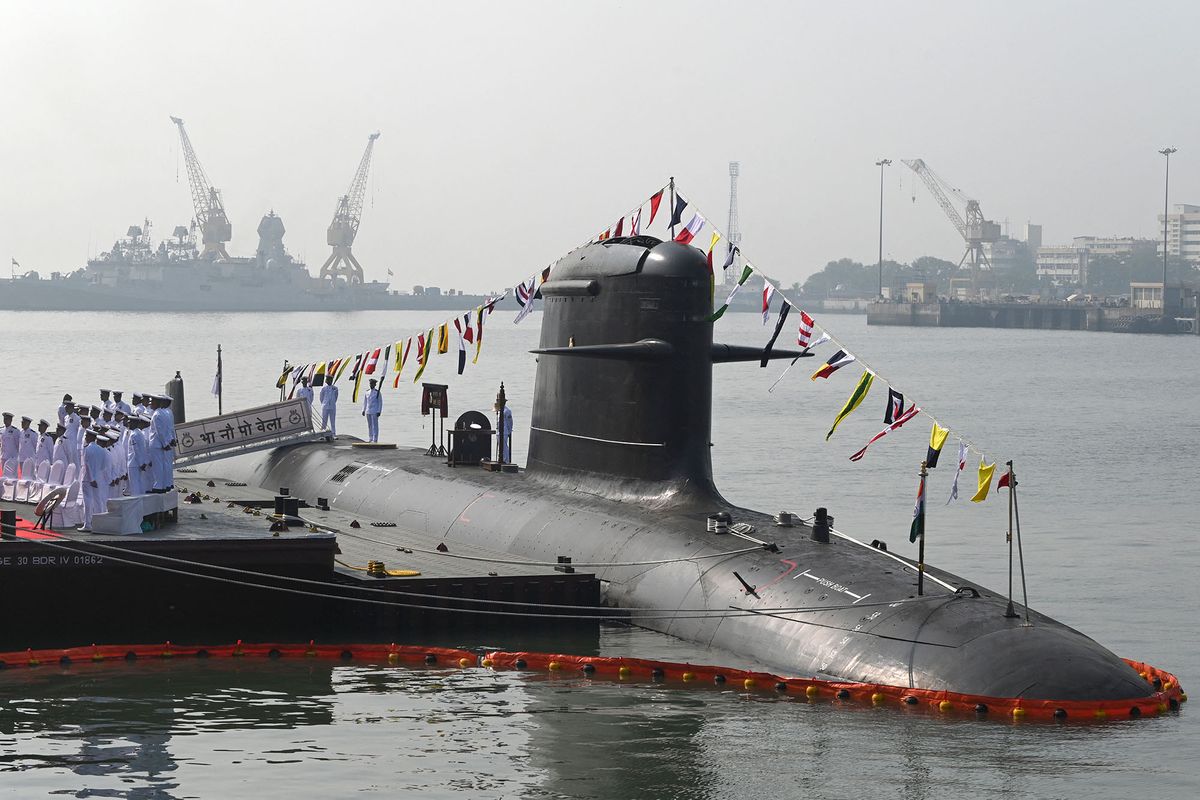 Sailors salute onboard the INS Vela, a French designed fourth Scorpene submarine under the Kalvari-class submarine Project-75, during its commissioning ceremony at the naval base in Mumbai on November 25, 2021. (Photo by Indranil MUKHERJEE / AFP)