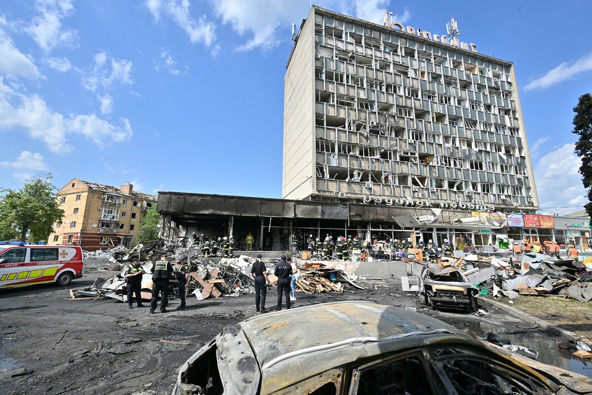 Firefighters inspect a damaged building following a Russian airstrike in the city of Vinnytsia, west-central Ukraine on July 14, 2022. - At least 20 people were killed Thursday by Russian strikes on a city in central Ukraine, bombings described as "an openly terrorist act" by Ukrainian President Volodymyr Zelensky. (Photo by Sergei SUPINSKY / AFP)