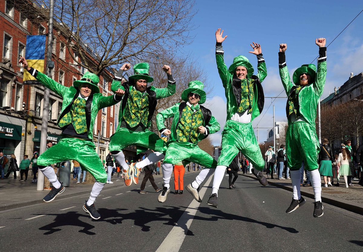 Revellers from Denmark dressed in green pose photo during the the annual St Patrick's Day parade in Dublin on March 17, 2022. (Photo by Damien EAGERS / AFP)