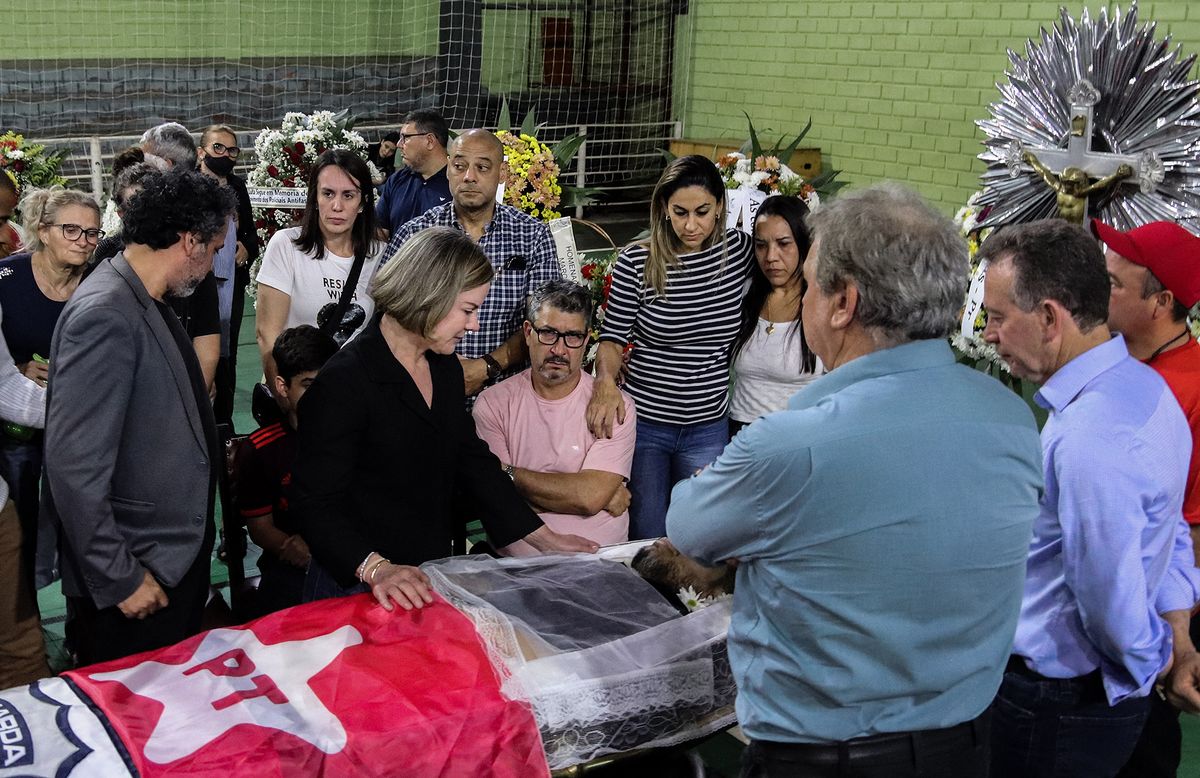 Workers Party (PT) president Gleisi Hoffmann (C) pays last respects to the leader of the PT in Foz do Iguacu Marcelo Arruda, during his wake in Foz do Iguacu, Parana state, Brazil, on July 10, 2022. Marcelo Arruda died earlier today after being shot by a follower of far-right president Jair Bolsonaro, who broke into his 50th birthday celebration, a fact labelled as "political violence" by the left-wing force.