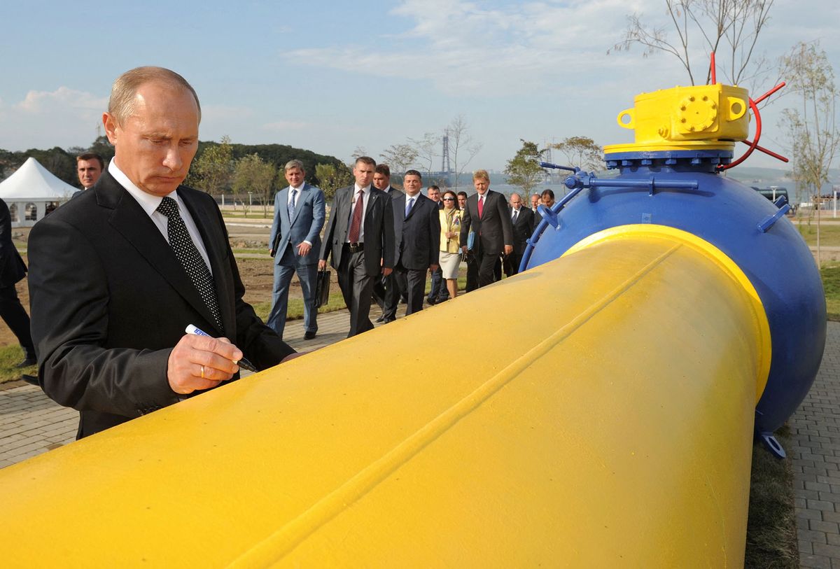 Russia’s Prime Minister Vladimir Putin signs an autograph on a natural gas pipeline Sakhalin-Khabarovsk-Vladivostok  in the Russian Far East city of Vladivostok on September 8, 2011, during the pipeline's launch ceremony. AFP PHOTO/ RIA-NOVOSTI POOL/ ALEXEY DRUZHININ (Photo by DMITRY ASTAKHOV / POOL / AFP)
