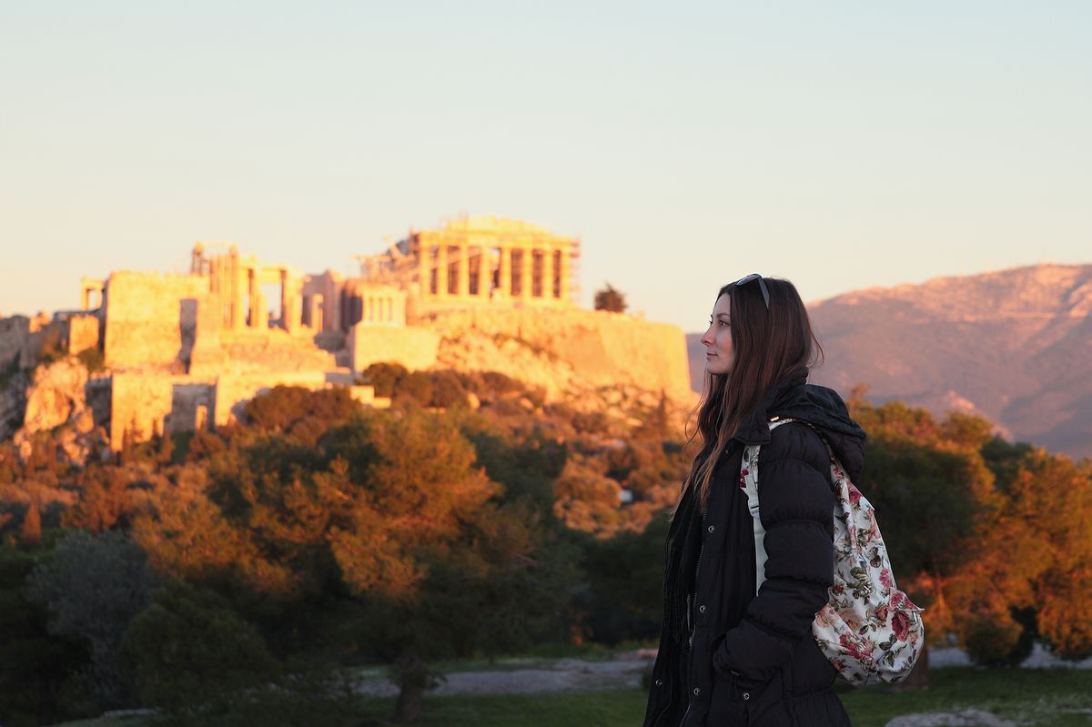 Young,Girl,Near,Fire,Sunset,Acropolis.student,In,Athens,greece.