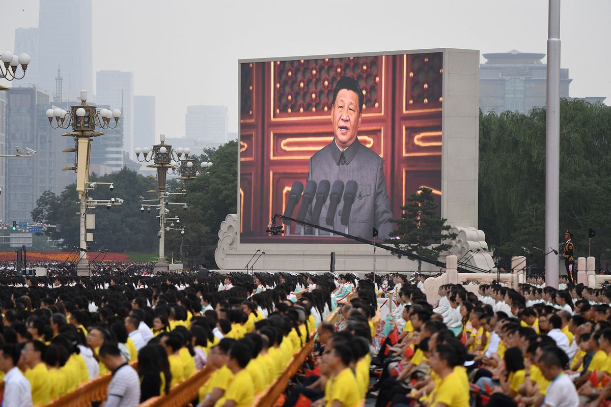 Chinese President Xi Jinping (on screen) delivers a speech during the celebrations of the 100th anniversary of the founding of the Communist Party of China at Tiananmen Square in Beijing on July 1, 2021. (Photo by WANG Zhao / AFP)