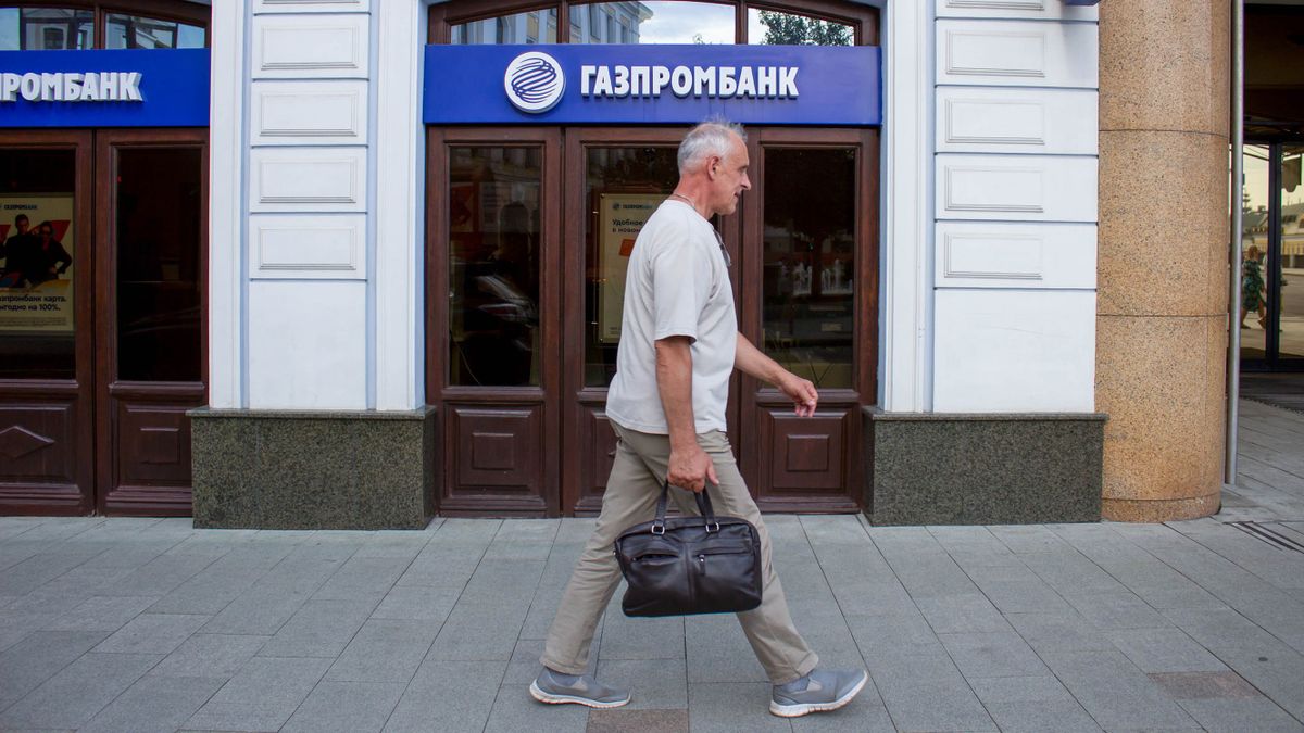 A man walks past a Gazprom bank office in Moscow. Gazprom