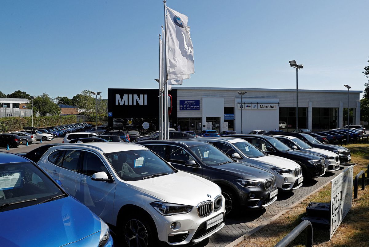 New and used cars are pictured on the forecourt at a re-opened BMW car dealership, in Hook, southwest of London, following the easing of the lockdown restrictions during the novel coronavirus COVID-19 pandemic on June 1, 2020. - Schools partially reopened in England on Monday and the most vulnerable were allowed to venture outdoors, despite warnings that the world's second worst-hit country was moving too quickly out of its coronavirus lockdown. (Photo by Adrian DENNIS / AFP)