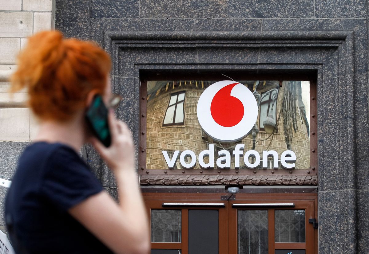 A,Woman,Looks,On,A,Logo,Of,Vodafone,On,A