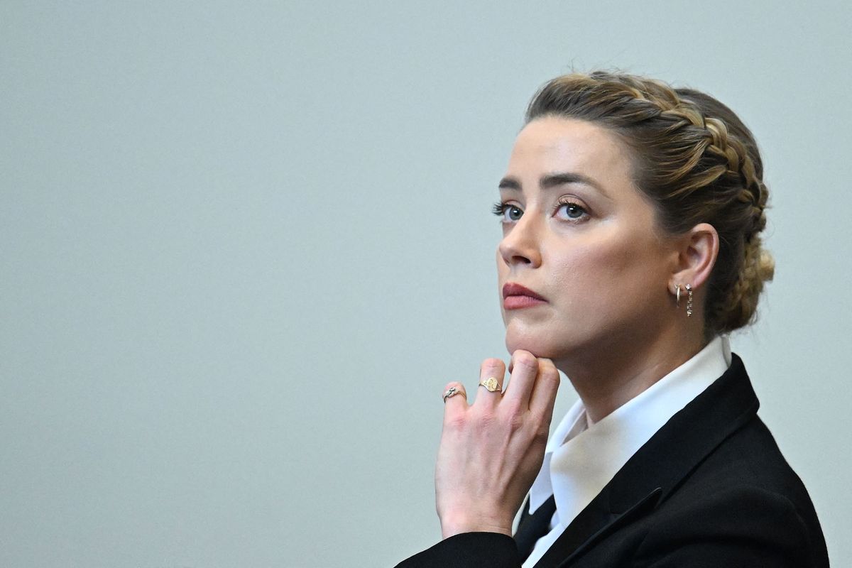 US actress Amber Heard looks on during a hearing at the Fairfax County Circuit Courthouse in Fairfax, Virginia, on May 3, 2022. - US actor Johnny Depp sued his ex-wife Amber Heard for libel in Fairfax County Circuit Court after she wrote an op-ed piece in The Washington Post in 2018 referring to herself as a "public figure representing domestic abuse." (Photo by JIM WATSON / POOL / AFP)