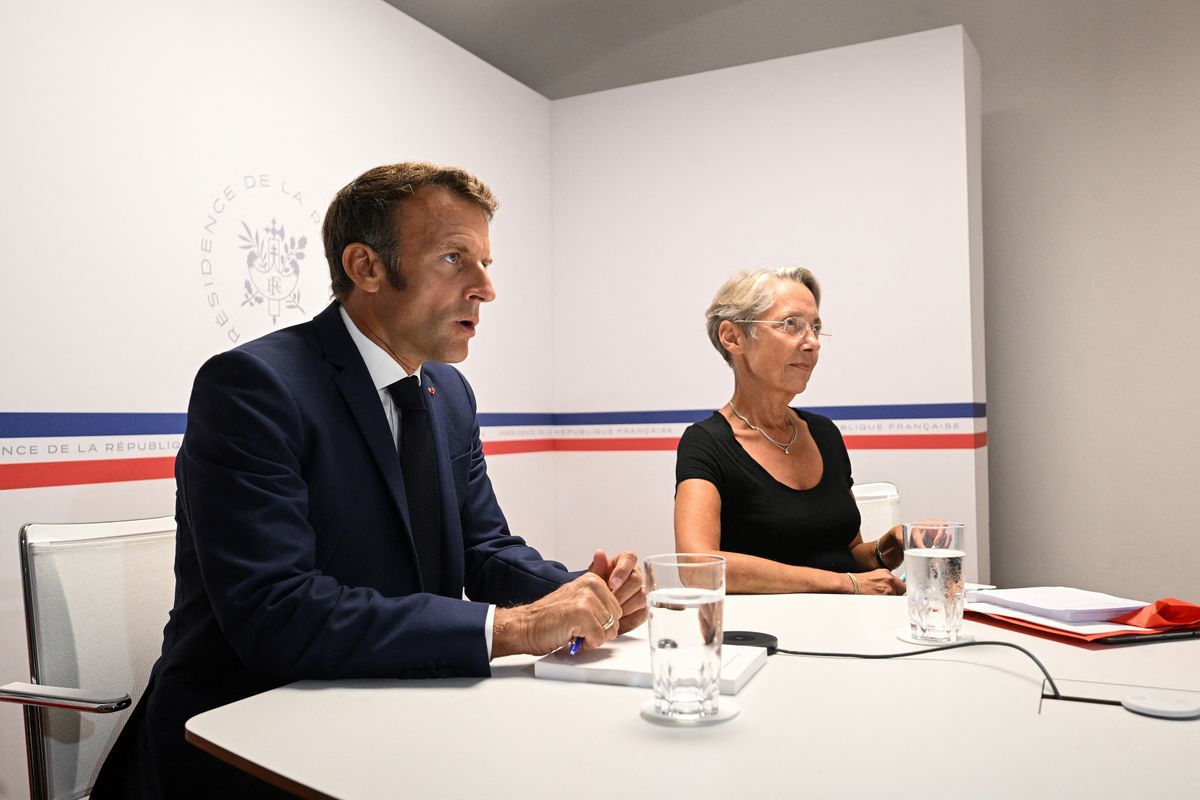France's President Emmanuel Macron (L) holds next to France's Prime Minister Elisabeth Borne (C) the interministerial crisis unit activated following the violent storms which caused five deaths in Corsica, at the Fort de Bregancon in Bormes-les-Mimosas, southern France, on August 18, 2022. - Brutal storms with winds gusting up to 224 kilometres per hour (140 miles per hour) left five people dead on the French Mediterranean island of Corsica early August 18, 2022, including a 13-year-old girl who was killed when a tree fell onto her campground bungalow, authorities said. (Photo by CHRISTOPHE SIMON / POOL / AFP)