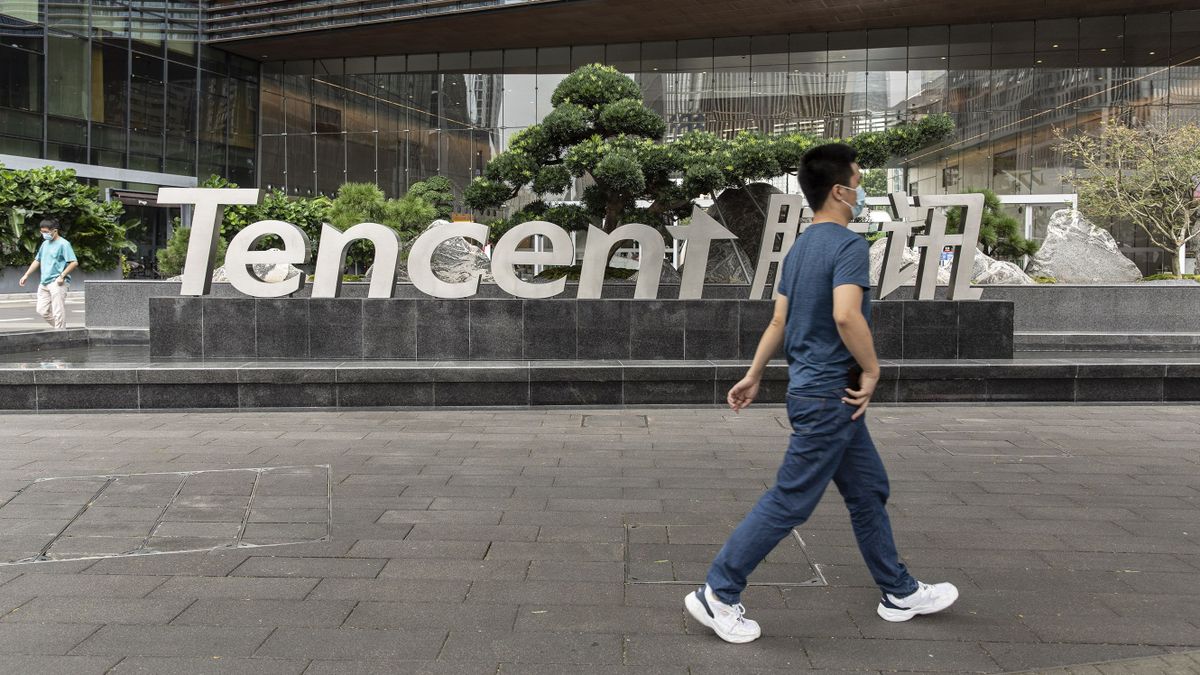 A pedestrian near signage for Tencent Holdings Ltd. at the company's headquarters in Shenzhen, China, on Tuesday, Oct. 12, 2021. Tencent imposed a rare ban on thursday on more than 1,000 WeChat accounts after China kicked off a two-month crackdown on commercial platforms and social media accounts posting financial information thats deemed harmful to its economy. 