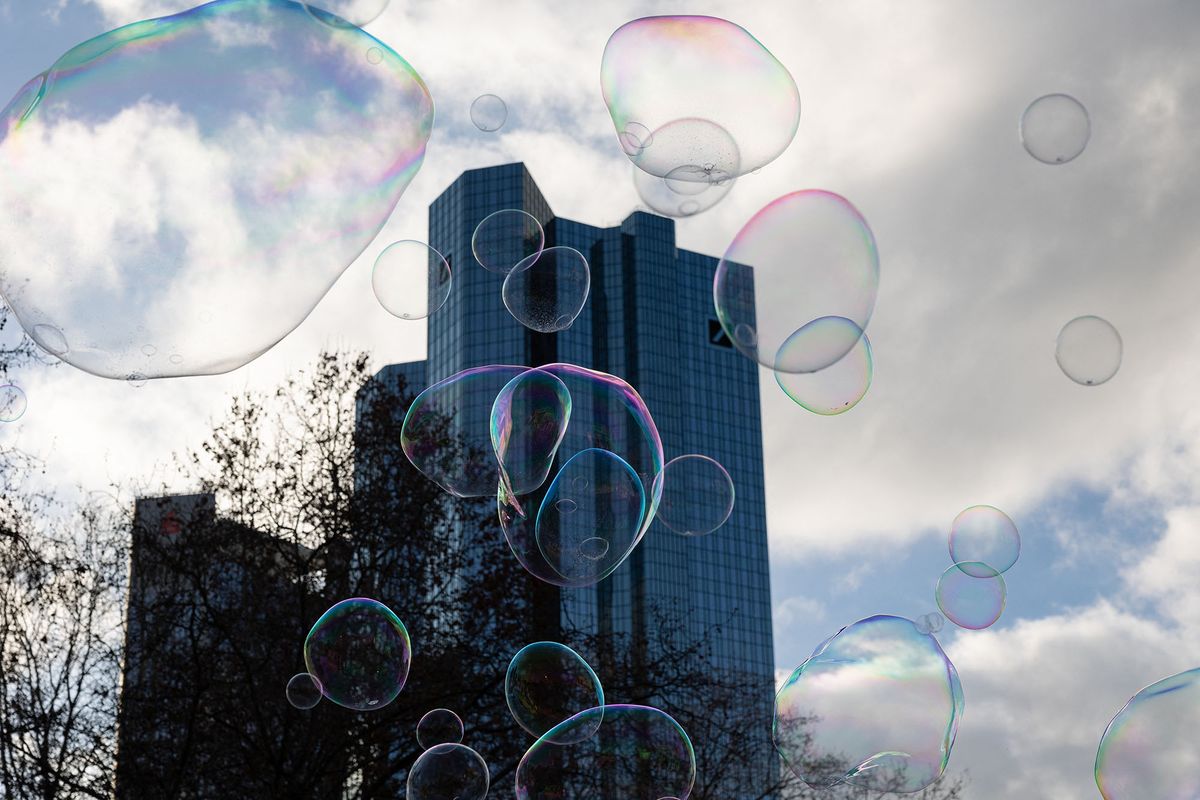 Soap bubbles are pictured in front of the headquarter of Deutsche Bank in Frankfurt am Main, western Germany, on February 5, 2022. (Photo by Yann Schreiber / AFP)