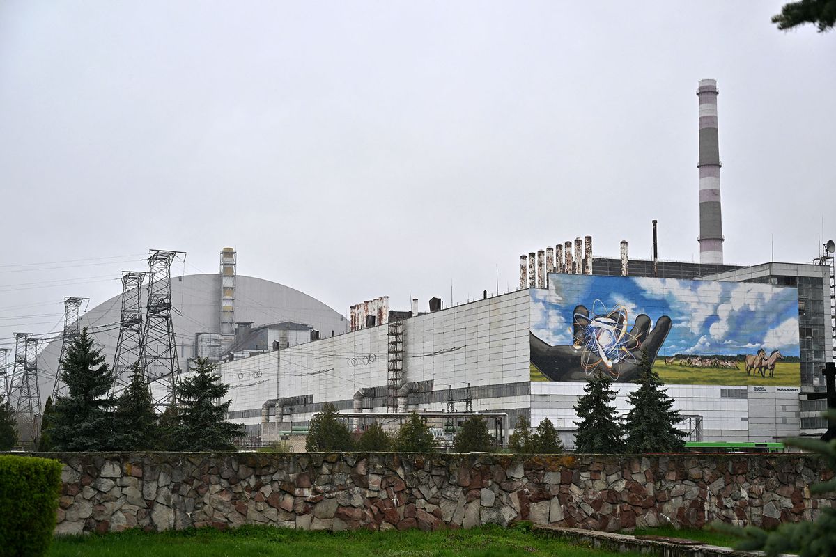 This photograph taken on April 26, 2022 shows the New Safe Confinement at Chernobyl Nuclear Power Plant which cover the number 4 reactor unit, on the 36th anniversary of the world's worst nuclear disaster. - Russia's temporary takeover of the Chernobyl site was "very, very dangerous" and raised radiation levels but they have now returned to normal, the head of the UN atomic watchdog said on April 26, 2022. (Photo by Sergei SUPINSKY / AFP)