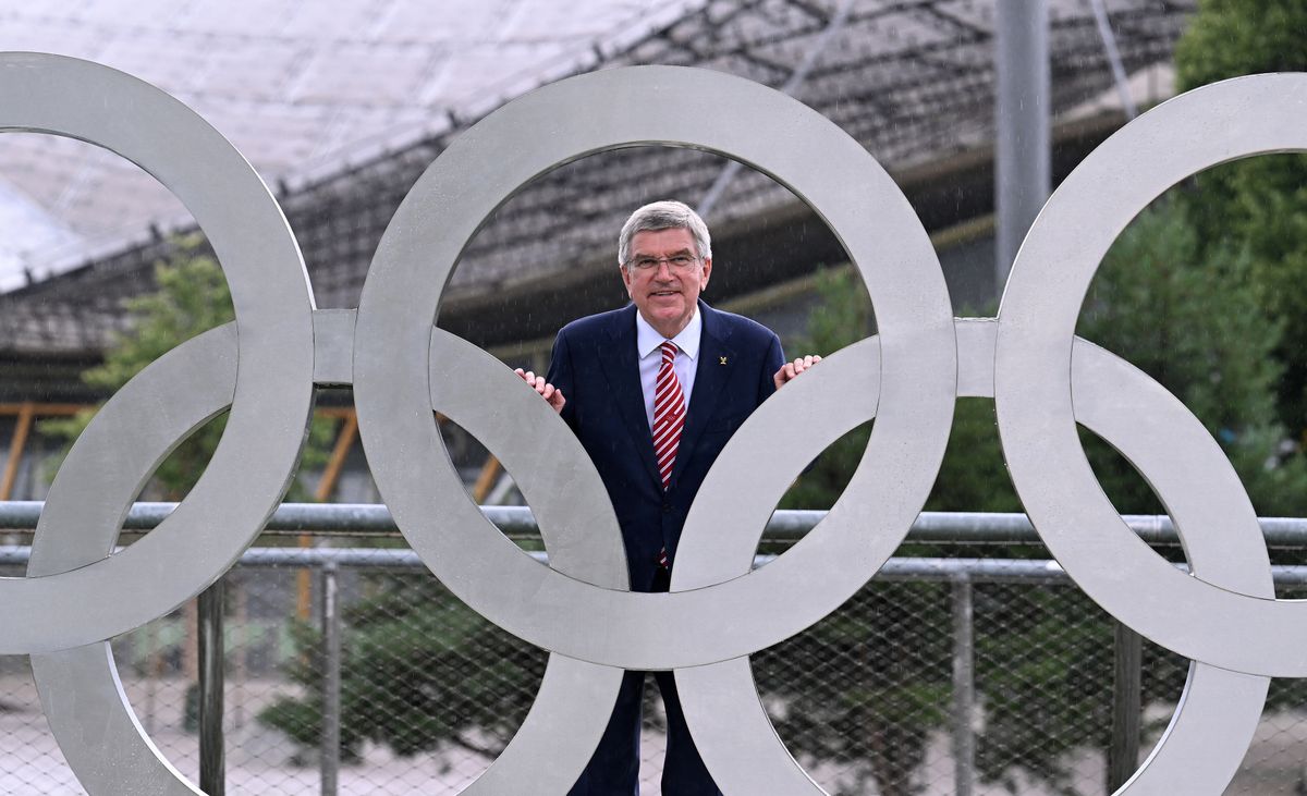International Olympic Committee President (IOC) Thomas Bach poses behind Olympic Rings during their inauguration on the roof of the small Olympic Hall to mark the 50th anniversary of the 1972 Summer Olympics in Munich on July 1, 2022. (Photo by Christof STACHE / AFP)