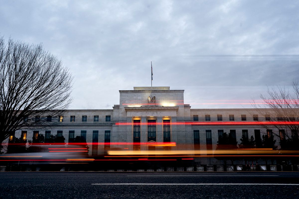 Vehicles drive past the Marriner S. Eccles Federal Reserve building in Washington, DC, on January 25, 2022. (Photo by Stefani Reynolds / AFP)
