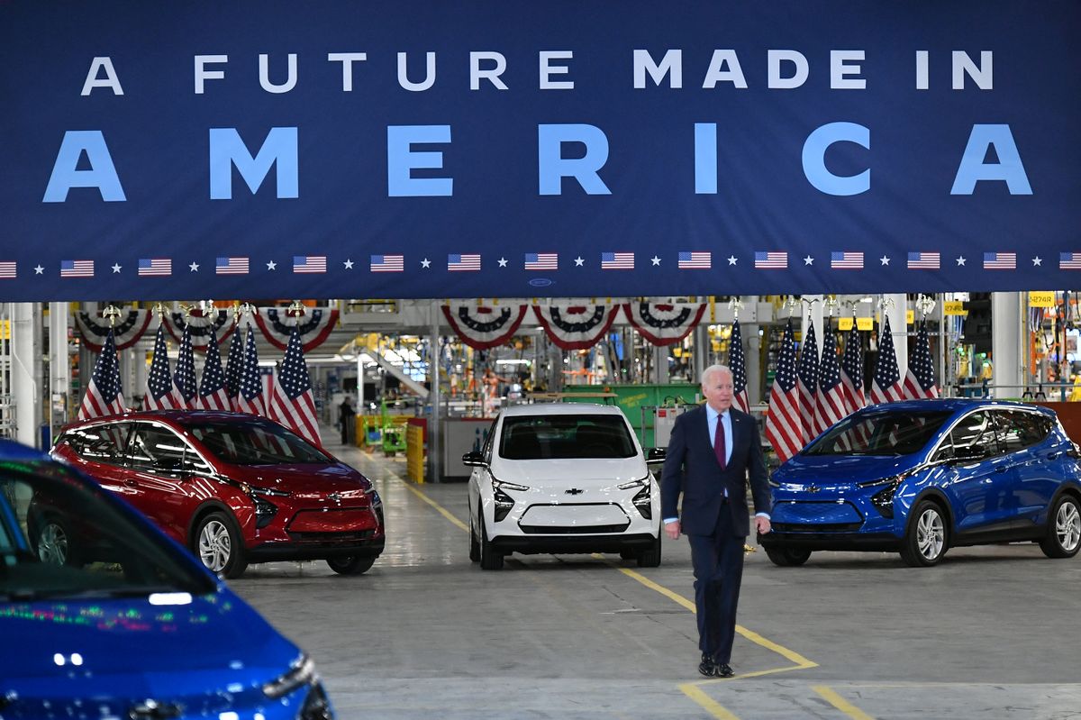 Chevy vehicles are seen behind US President Joe Biden as he arrives to deliver remarks during a visit to the General Motors Factory ZERO electric vehicle assembly plant in Detroit, Michigan 