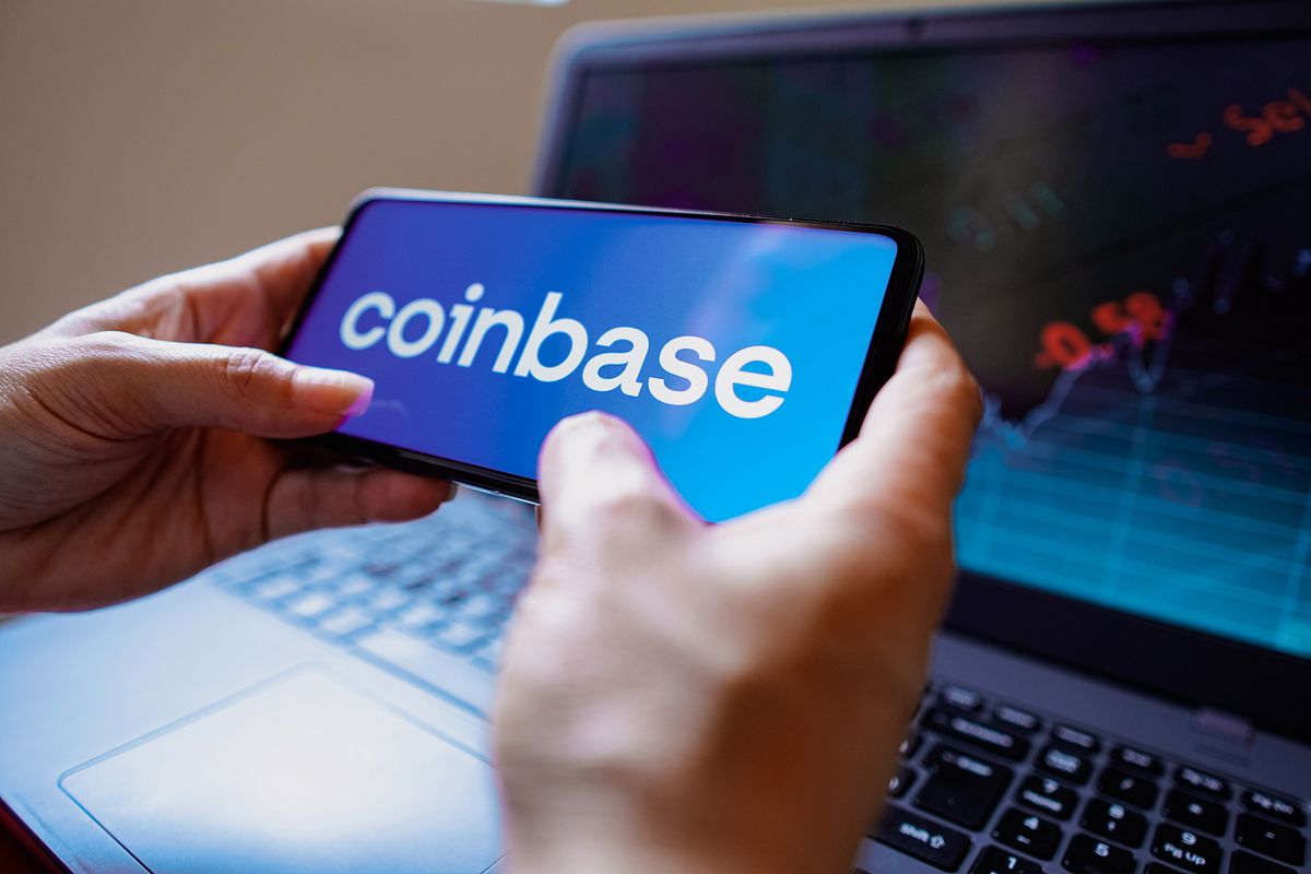 In this photo illustration, the Coinbase logo seen displayed