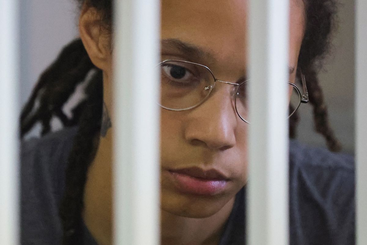 US' Women's National Basketball Association (WNBA) basketball player Brittney Griner, who was detained at Moscow's Sheremetyevo airport and later charged with illegal possession of cannabis, waits for the verdict inside a defendants' cage during a hearing in Khimki outside Moscow, on August 4, 2022. - A Russian court found Griner guilty of smuggling and storing narcotics after prosecutors requested a sentence of nine and a half years in jail for the athlete. (Photo by EVGENIA NOVOZHENINA / POOL / AFP)
