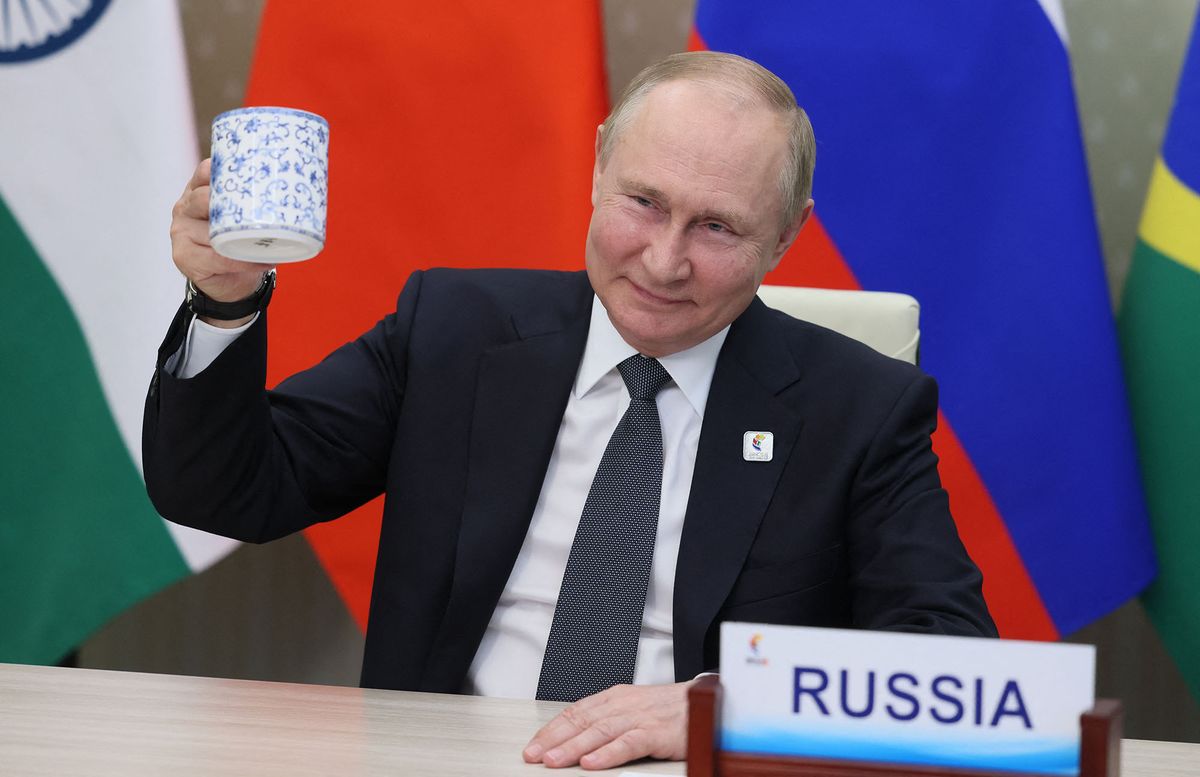 Russian President Vladimir Putin makes a toast as he takes part in the XIV BRICS summit in virtual format via a video call, in Moscow on June 23, 2022. (Photo by Mikhail Metzel / SPUTNIK / AFP)