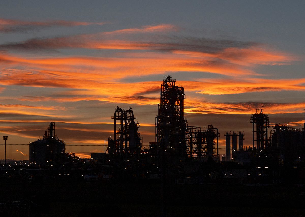 The sun goes down behind the largest Austrian refinery plant OMV in Schwechat, Austria