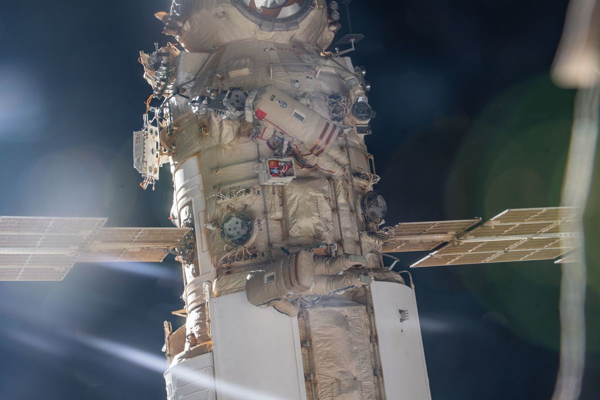 Cosmonauts Oleg Artemyev and Denis Matveev of Roscosmos are pictured attached to the Nauka multipurpose laboratory module during a spacewalk on April 28, 2022, to activate the European robotic arm on the International Space Station.