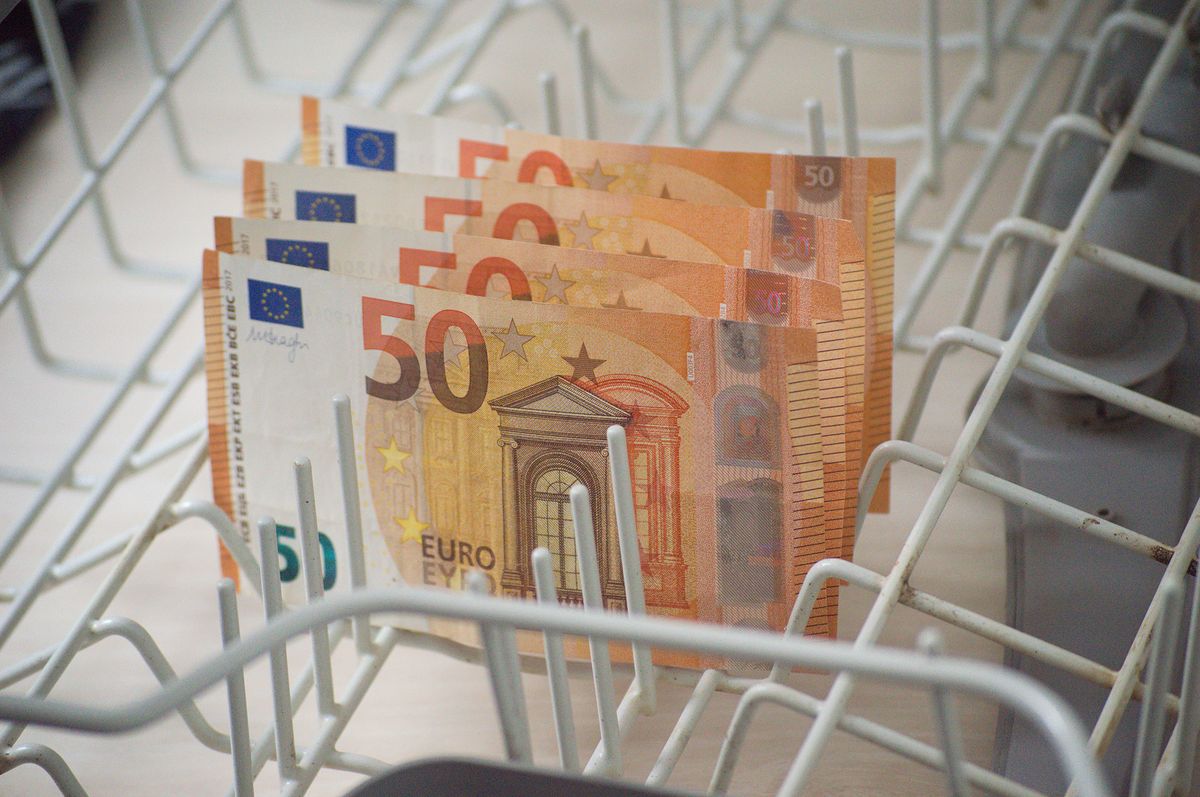 Banknotes in a dishwasher as a symbol of money washing