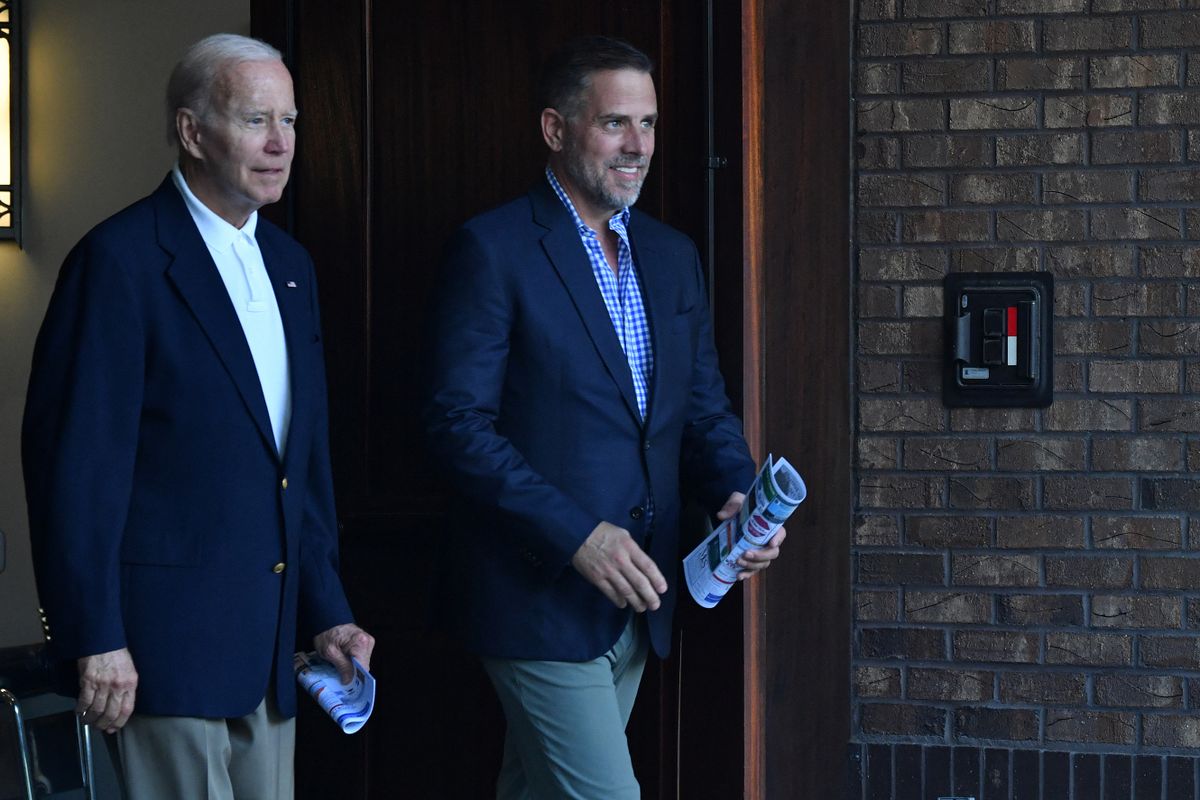 US President Joe Biden (L) alongside his son Hunter Biden  exit Holy Spirit Catholic Church after attending mass in Johns Island, South Carolina on 