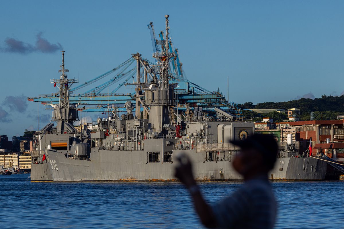 KEELUNG, TAIWAN - AUGUST 07:  A man takes picture at the harbour where Taiwanese Navy warships are anchored on August 07, 2022 in Keelung, Taiwan. Taiwan remained tense after Speaker of the U.S. House Of Representatives Nancy Pelosi visited earlier this week, as part of a tour of Asia aimed at reassuring allies in the region. China has been conducting live-fire drills in waters close to those claimed by Taiwan in response. 