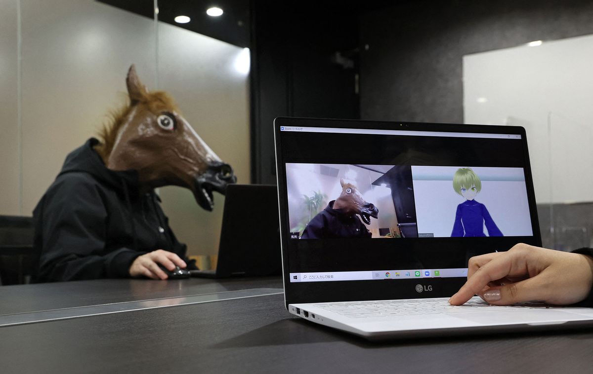 An organizer, wearing a  horse-face mask demonstrates for a job-hunting service in Naniwa, Osaka Prefecture on March 2nd, 2022. The IT venture corporation,  Beyond  held a virtual reality interview event in order to provide avatar characters with students in the metaverse. The students who seek a job show their personality by  being an avatar charachter.   ( The Yomiuri Shimbun ) (Photo by Naoki Maeda / Yomiuri / The Yomiuri Shimbun via AFP)